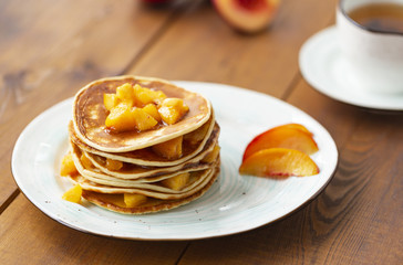 Pancakes with honey and fruit. Delicious breakfast.