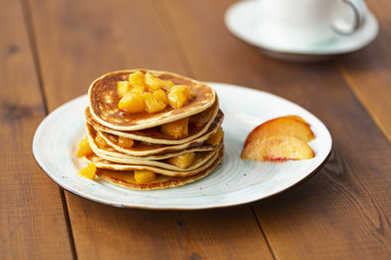 Pancakes with honey and fruit. Delicious breakfast.