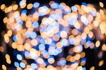 full frame of blue and golden defocused bokeh lights on black background