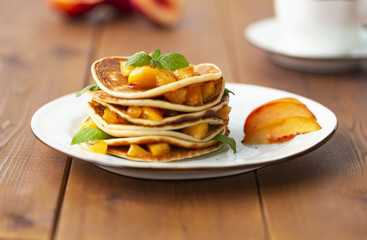 Pancakes with honey and fruit. Delicious breakfast.