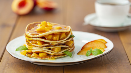 Pancakes with honey and fruit. Delicious breakfast.