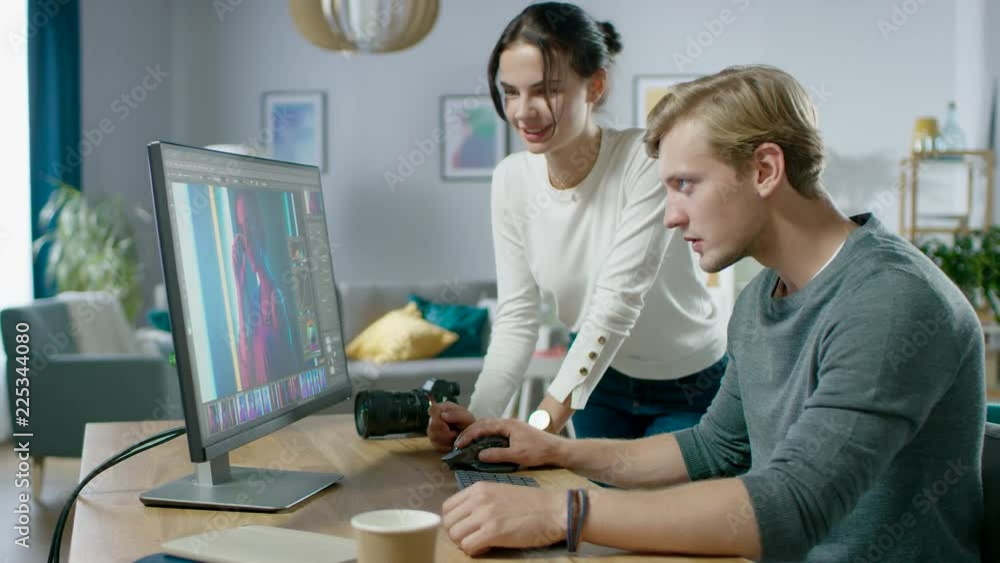 Poster male and female professional editors talk while working in photo editing app / software on a persona