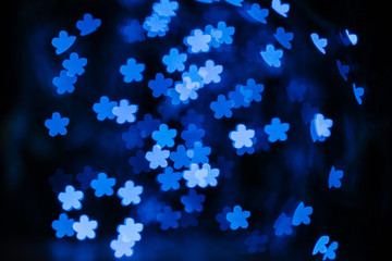 beautiful blue shiny stars bokeh on black background