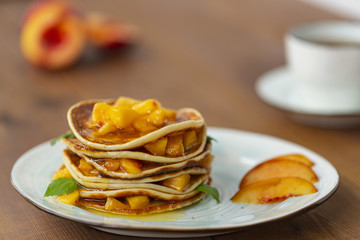 Pancakes with honey and fruit. Delicious breakfast.