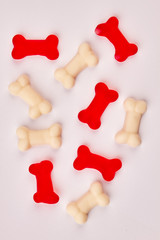 Obraz premium Red and white gummy candies in shape of bones. Colorful jelly bones. Junk food and confectionery concept.