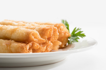 Cigar Pastries on a white plate.