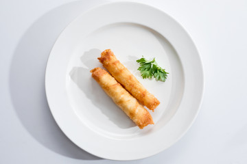 Cigar Pastries on a white plate.