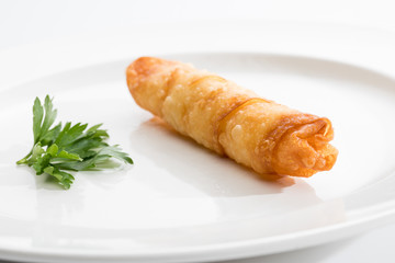 One Cigar pastry on a white plate.