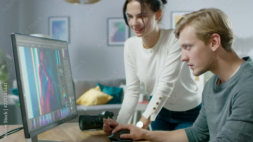Poster male and female professional editors talk while working in photo editing app / software on a persona
