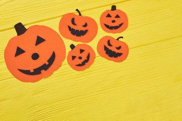 Halloween pumpkin paper silhouettes. Orange paper silhouettes in a shape of Jack-O-Lantern for Halloween. Holidays, decorations and party concept.