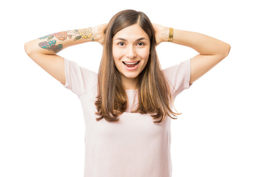 Excited Brunette Woman With Hands Behind Head