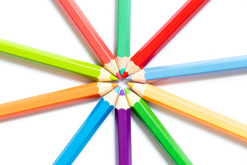 Fototapeta premium Color pencil arrange in ray shape on white paper background