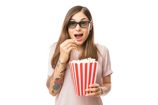 Excited Woman Having Popcorn While Watching 3D Movie