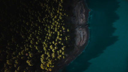 drone shot from above of forest close to a lake