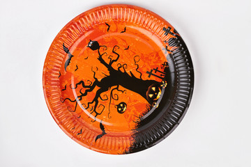Halloween holiday plate isolated. Orange plate with black tree pattern for Halloween. Halloween dishware design.