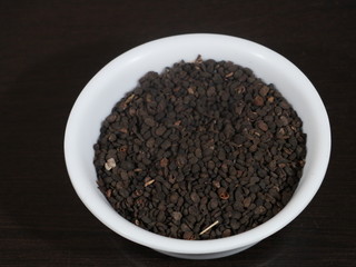 black Sesame close up shot on wood background,Black Sesame seeds in wooden isolated on wooden background, Black Sesame Seed in White Bowl on Wooden background, Black Sesame Seeds in Hand,