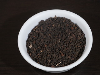 black Sesame close up shot on wood background,Black Sesame seeds in wooden isolated on wooden background, Black Sesame Seed in White Bowl on Wooden background, Black Sesame Seeds in Hand,