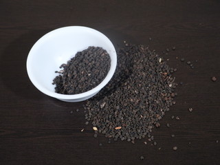 black Sesame close up shot on wood background,Black Sesame seeds in wooden isolated on wooden background, Black Sesame Seed in White Bowl on Wooden background, Black Sesame Seeds in Hand,