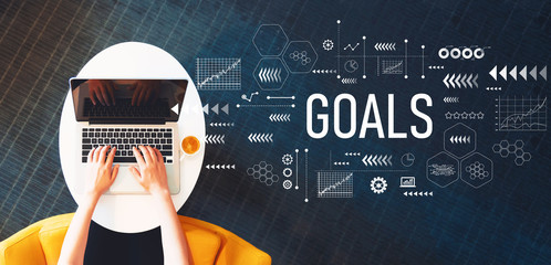 Goals with person using a laptop on a white table