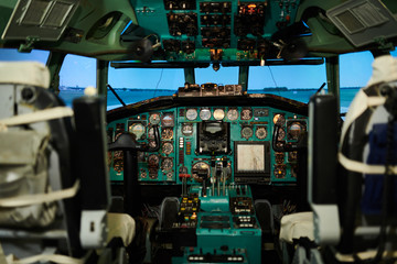 Wide angle view at empty jet cabin with meters and switches on control panel, copy space