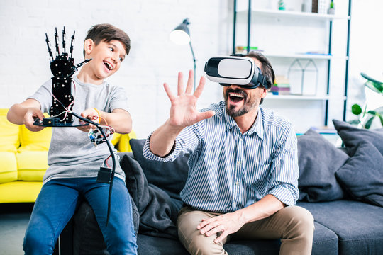 Joyful father and his son testing modern robot