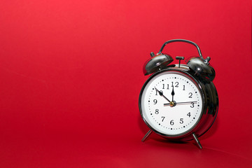 alarm clock on red background. close up shot. top view, time concept.