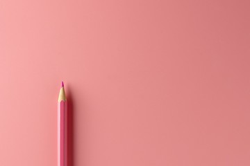 pink crayon pencil on pink paper background. - Business concept