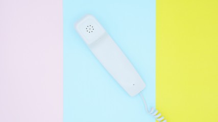 telephone receiver on blue pink and yellow background.