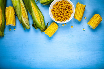 Raw and canned corn in a white bowl.