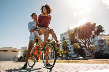 Couple riding bicycle in street