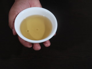 Olive oil on a wooden background, Fresh Olive Oil in White Bowl on Wooden Background, Olive in White Bowl on Hand in Wooden Background, Olive Oil