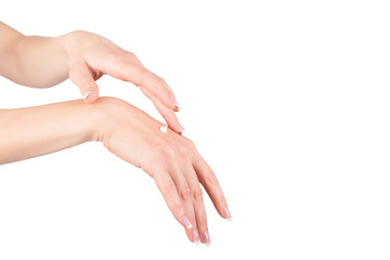 Female hands applying hand cream, white background, closeup