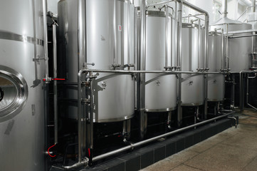 Modern brewery and equipment machinery tools for alcohol production. Steel vats or tanks and...