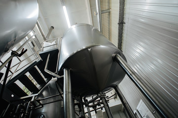 Modern brewery and equipment machinery tools for alcohol production. Steel vats or tanks and...