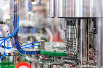 Modern filling machine of beverage in the factory