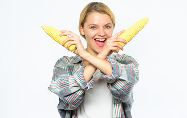 Food vegetarian and healthy organic products. Agriculture and fall crops concept. Fall harvest concept. Woman farmer hold yellow corn cob on white background. Girl rustic style hold ripe corn in hand