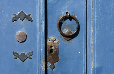 Old knocker on door of vibrant color
