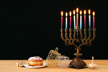 image of jewish holiday Hanukkah background with menorah (traditional candelabra) and burning candles.