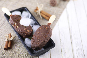 Dessert chocolate ice cream with nuts on wooden stick