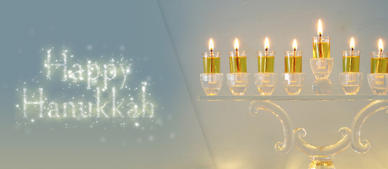 image of jewish holiday Hanukkah background with crystal menorah (traditional candelabra) and...