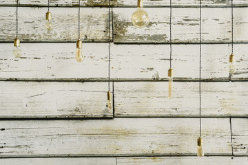 Wooden background with light bulbs of different sizes for decoration.