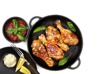 Fried chicken drumstick with sesame in a frying pan