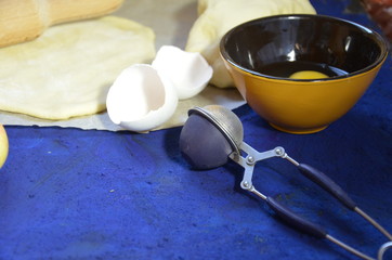 Various ingredients for winter seasonal baking and other recipes, honey, apples, herbs and spices on a dark blue background. Top view.