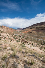 The road through Arches National Park on a partly cloudy sunny day in Utah