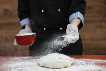 the cook makes flour for baking on the table