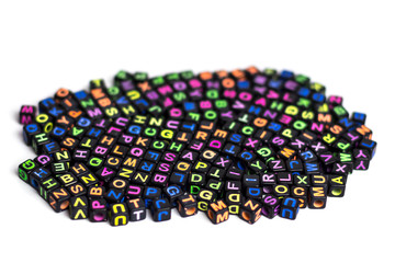 Many colorful decorative cubes with letters on a white background, slide view