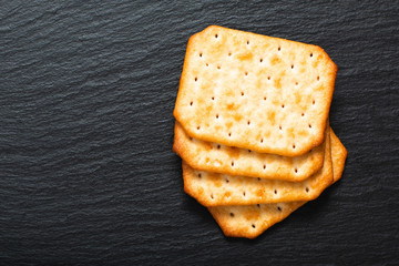 Food appetizer salted Crackers on black slate board with copy space