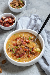 Lentil pea soup garnish with bacon and croutons