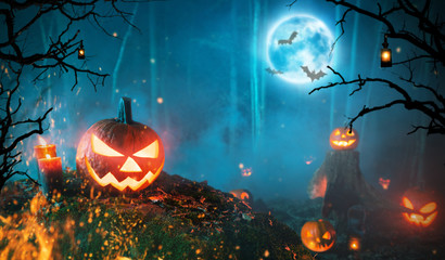 Spooky halloween pumpkins in dark forest