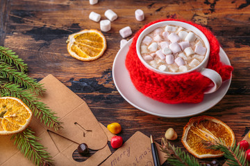 hot chocolate cacao with marshmallows knitted hand made red cloth for a mug